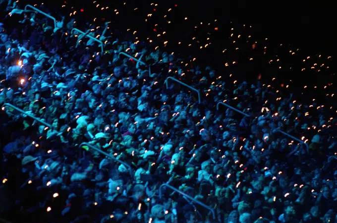 On September 15th, 2000, an audience of 110,000 inside Olympic Stadium bathes in blue light and become performers as they wave flashlights and blinking lights during the opening ceremonies for the Sydney 2000 Olympics. Base: Sydney State: New South Wales Country: Australia (AUS)