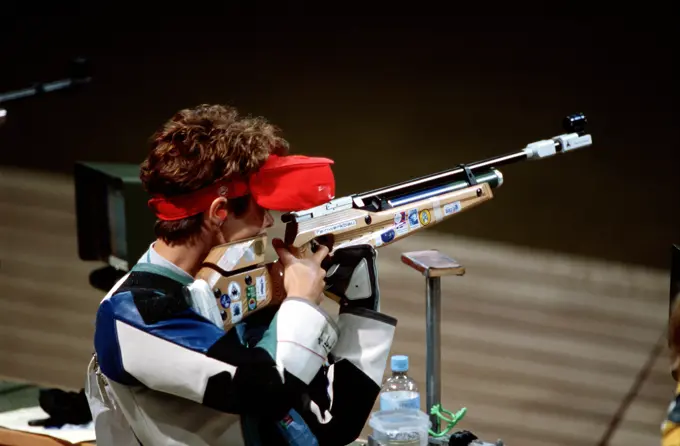 High angle, right rear view of Nancy Johnson as she takes aim for an Olympic gold medal during the Women's 10-meter Air Rifle Competition which she won, and claimed the first gold medal at the 2000 Olympic games in Sydney, Australia, September 16th, 2000. Nancy is married to US Army STAFF Sergeant Ken Johnson (Not shown) who is also on the US shooting team. He competes in the Men's 10-meter Air Rifle Competition. Base: Sydney State: New South Wales Country: Australia (AUS)