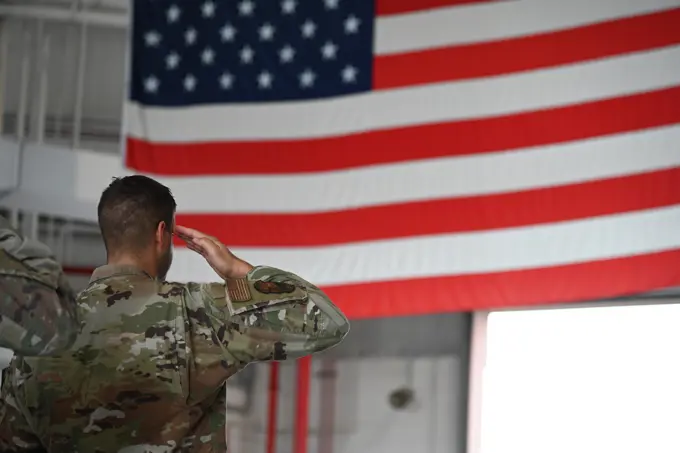 U.S. Air Force Maj. Joseph Carpentieri, commander, Base Defense Squadron, salutes during the 9/11 Day Remembrance Ceremony Sept. 11, 2022 at Stewart Air National Guard Base, Newburgh, New York. Carpentieri, while in formation, saluted during the singing of the national anthem.