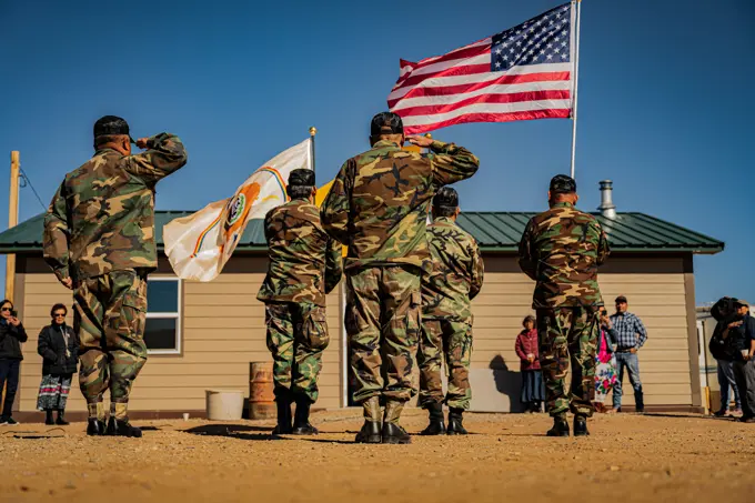 Members of the Shiprock Veterans Color Guard post the colors during a home-blessing ceremony for a Navajo Nation veteran in Shiprock, New Mexico, Feb. 28, 2024. Four Airmen representing the Indigenous Nations Equality Team attended the event to show support for their fellow Native American service members and veterans.  Air Force