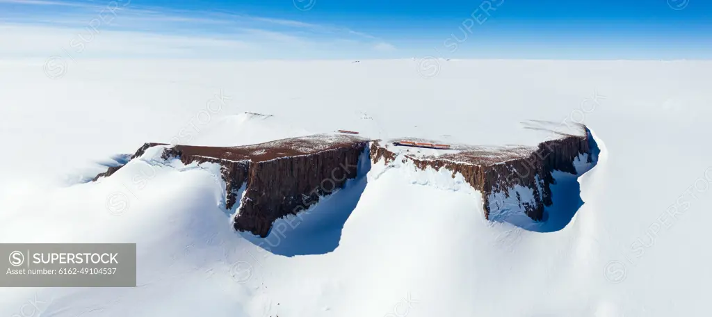 Panoramic aerial view of the SANAE IV base on a mountain surrounded by snow in Antarctica