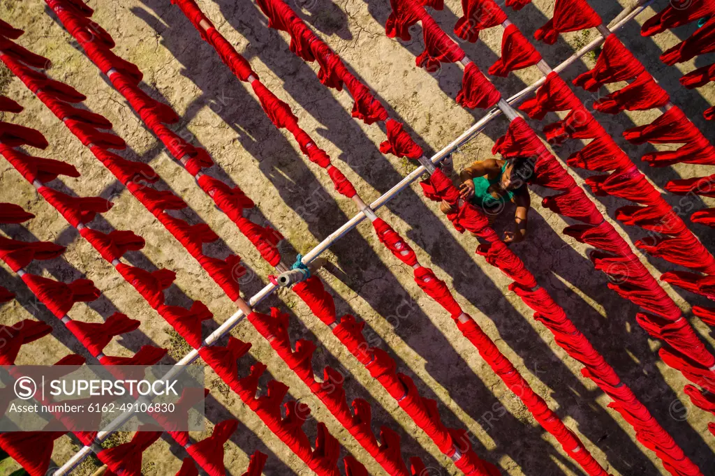 Aerial view of people working in a public laundry draining clothes at sunlight, Araihazar, Dhaka province, Bangladesh.