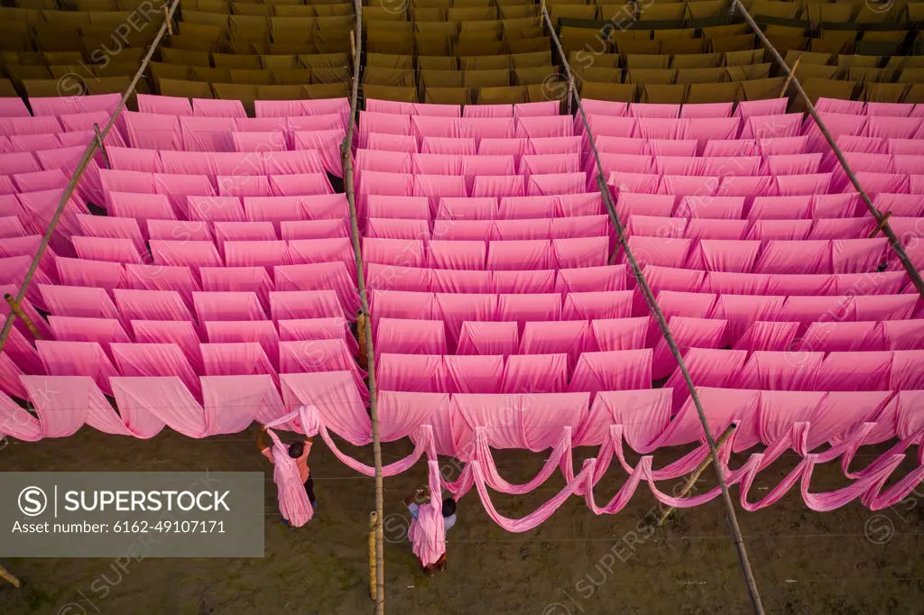 Aerial view of a person working in a public laundry hanging for drying colourful cloth in Narayanganj, Dhaka, Bangladesh.