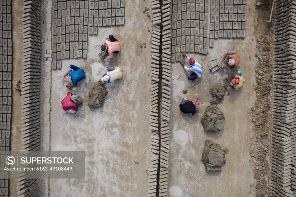 Aerial view of a brick factory from above, people working arranging the bricks near Keraniganj township, Dhaka province, Bangladesh.