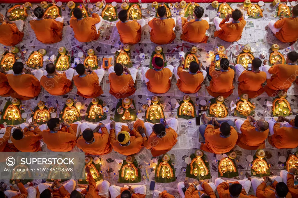 Narayanganj, Bangladesh - 10 November 2018: View of a crowd of people celebrating Rakher festival with oil lamp and burning incense in Narayanganj, Bangladesh.