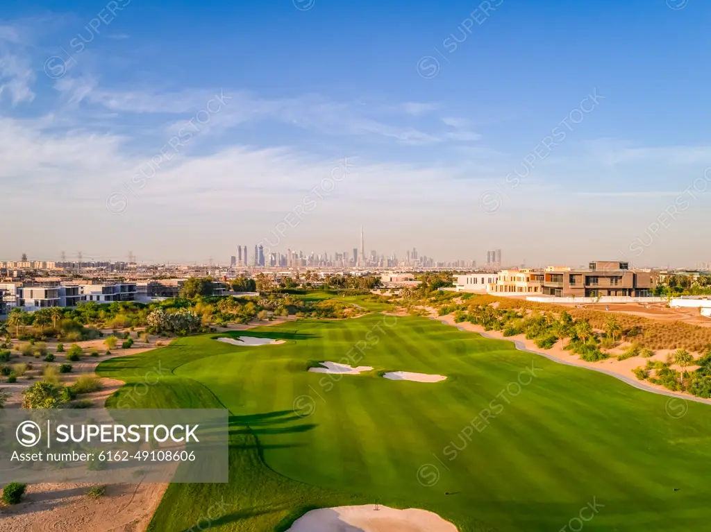 Aerial view of luxury golf club with Dubai at the background, U.A.E.