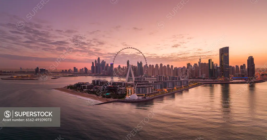 Panoramic Aerial view of Dubai skyline at sunset with Ain Dubai in foreground, the world's largest Ferris wheel, Dubai, United Arab Emirates.