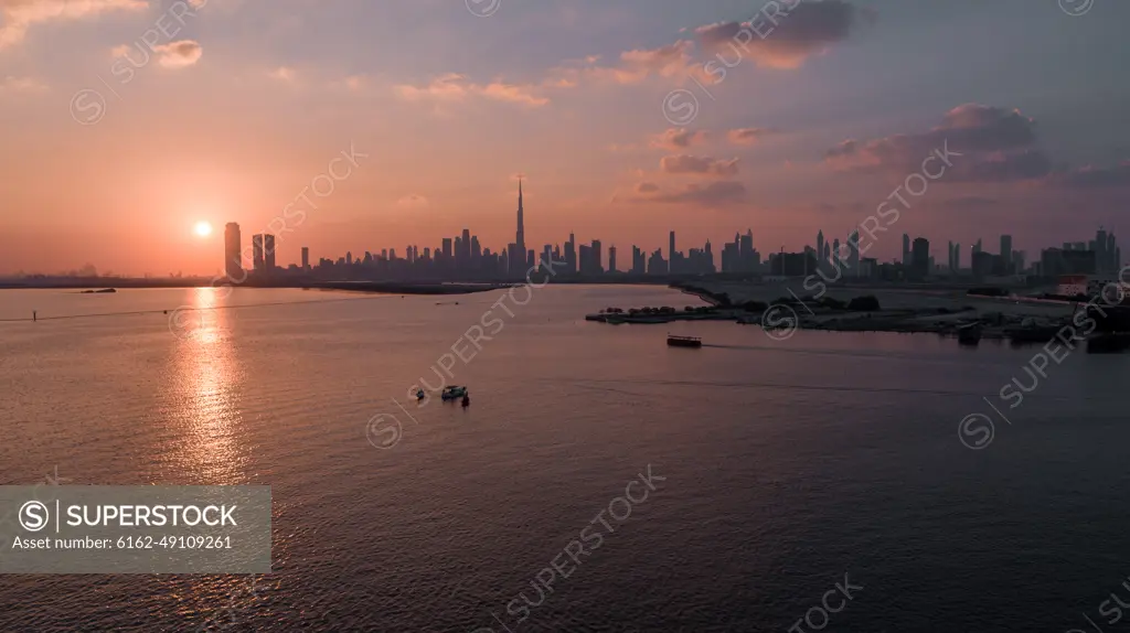 Aerial view of Dubai skyline facing the creek during a beautiful sunset, Dubai, United Arab Emirates.