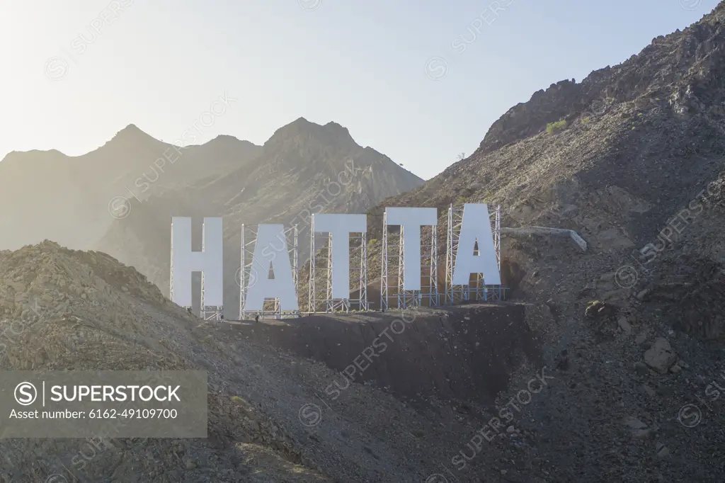 Dubai, United Arab Emirates - February 2022: Aerial view of the sign on the mountain top in Hatta, Dubai.