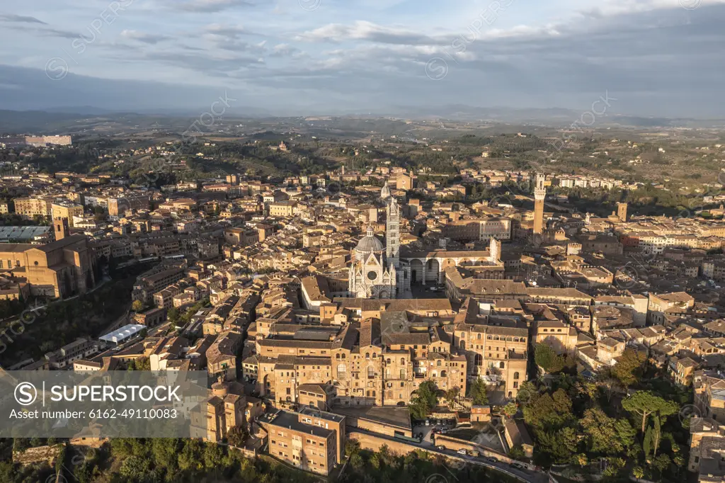 Panoramic aerial view of Siena cathedral in Siena downtown at sunset, Tuscany, Italy.