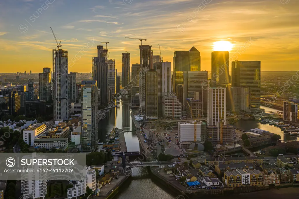 Aerial view of Canary Wharf financial district along the River Thams in London at sunset, United Kingdom.