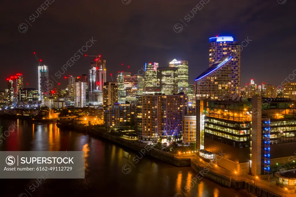 London, United Kingdom - 29 December 2020: Aerial view of London skyline along the river Thames at night.