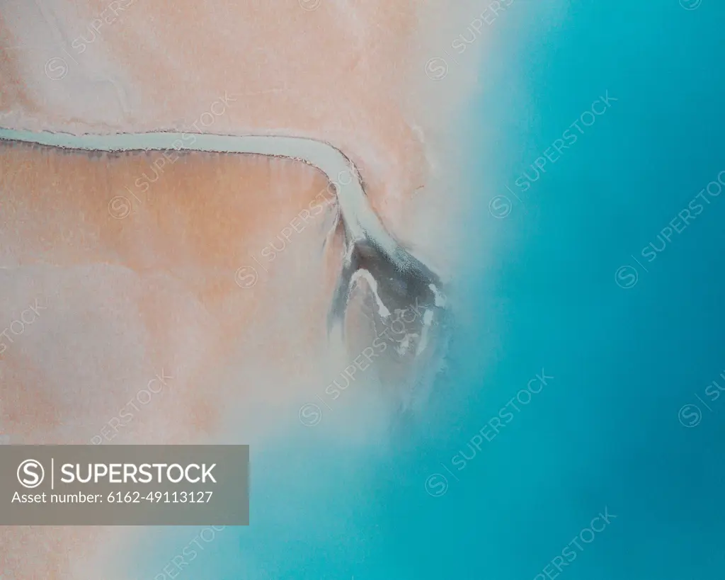 Aerial view of an abstract blue and turquoise clay lake, Art-sur-Meurthe, France.