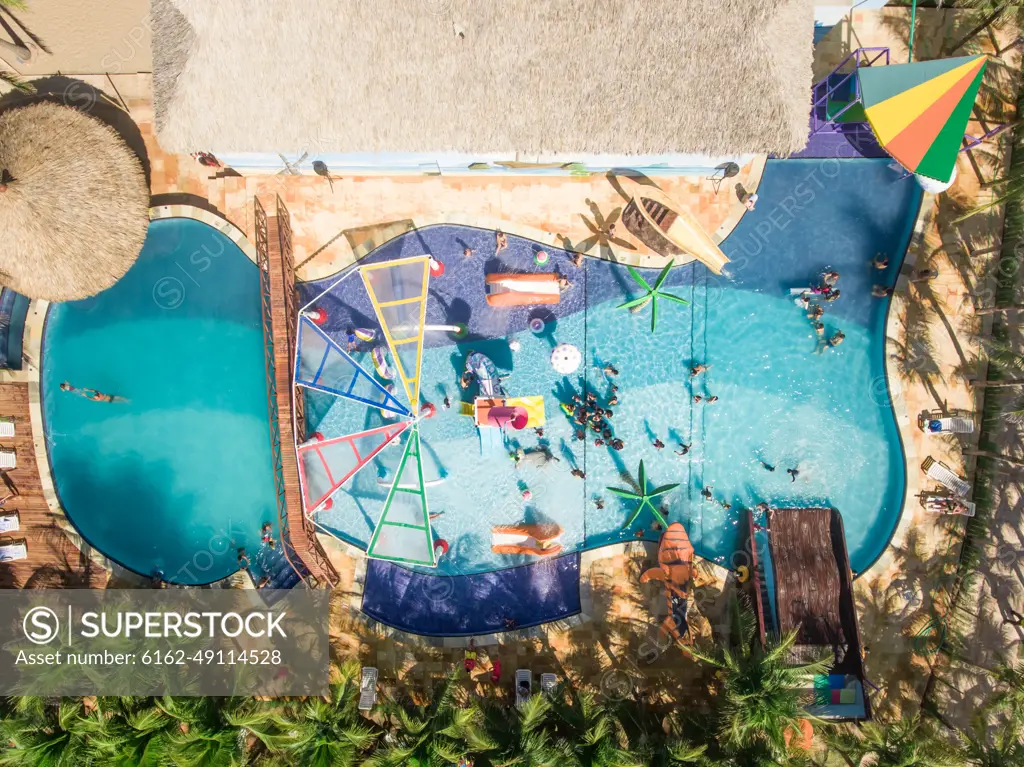 FORTALEZA, BRAZIL - 29 July 2016 : Aerial view of people swimming in swimming pool close to the beach in Brazil.