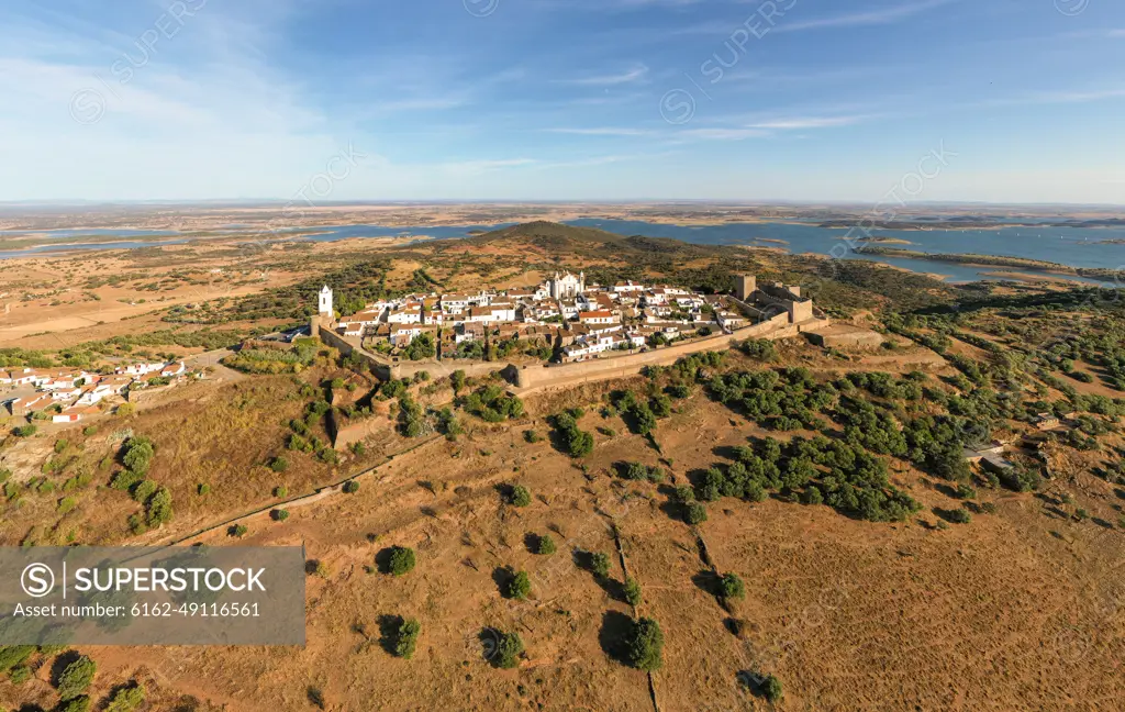 Aerial view of the Monsaraz Castle on a hill overlooking countryside, Portugal.