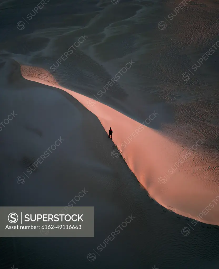 Aerial view of someone exploring during sunrise on the Lancelin Sand Dunes, Western Australia