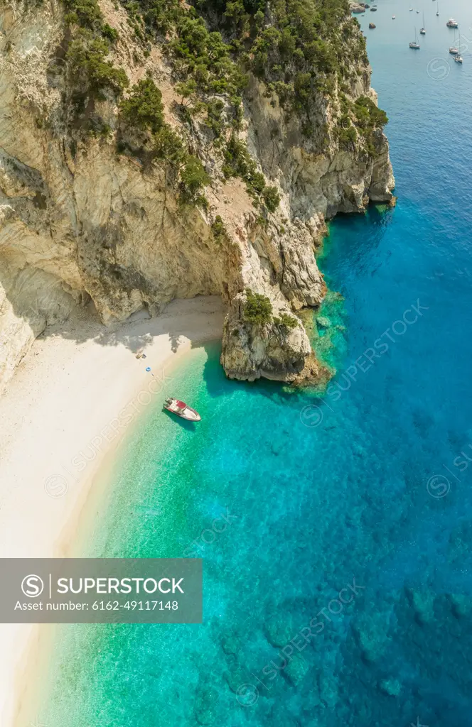 Aerial view of boat anchored on beach in Sivota, Greece.