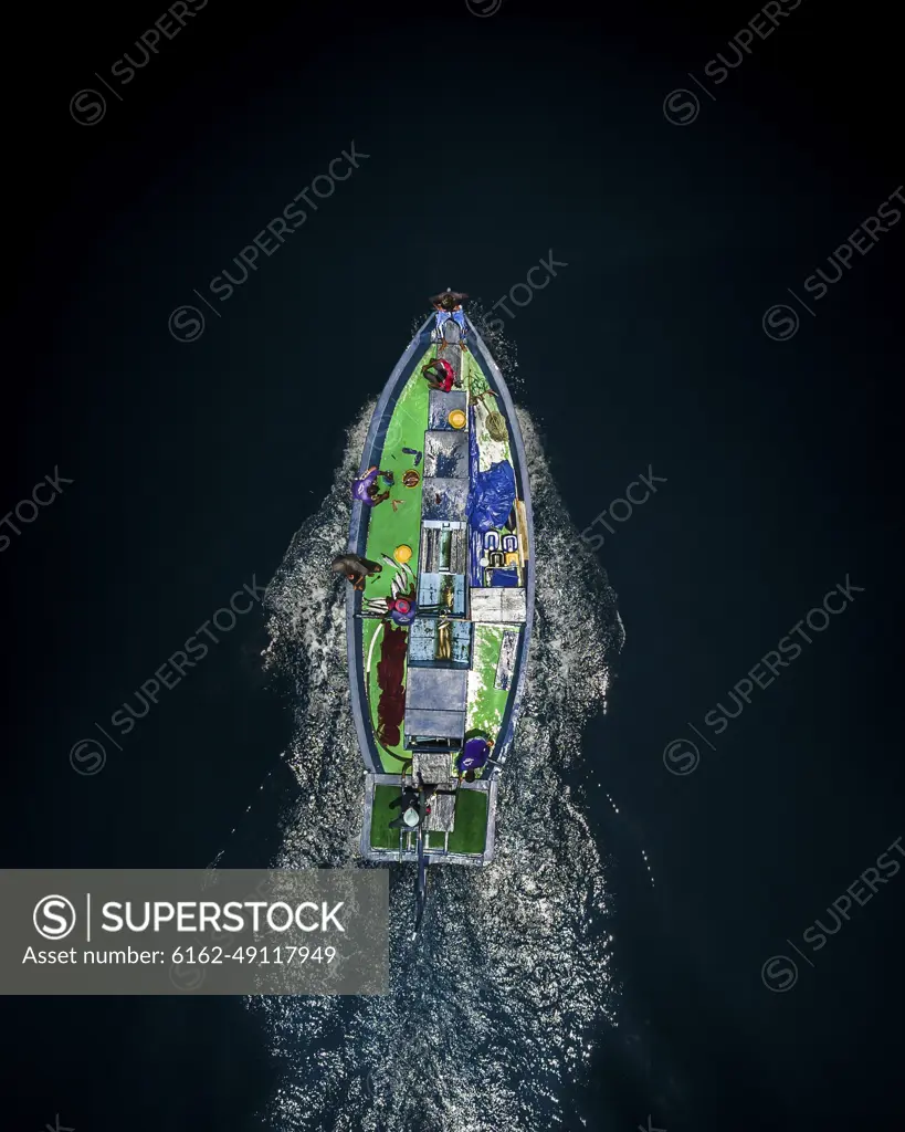 Aerial view of a traditional fishing boat cruising through the ocean in Kaafu atoll, Maldives.