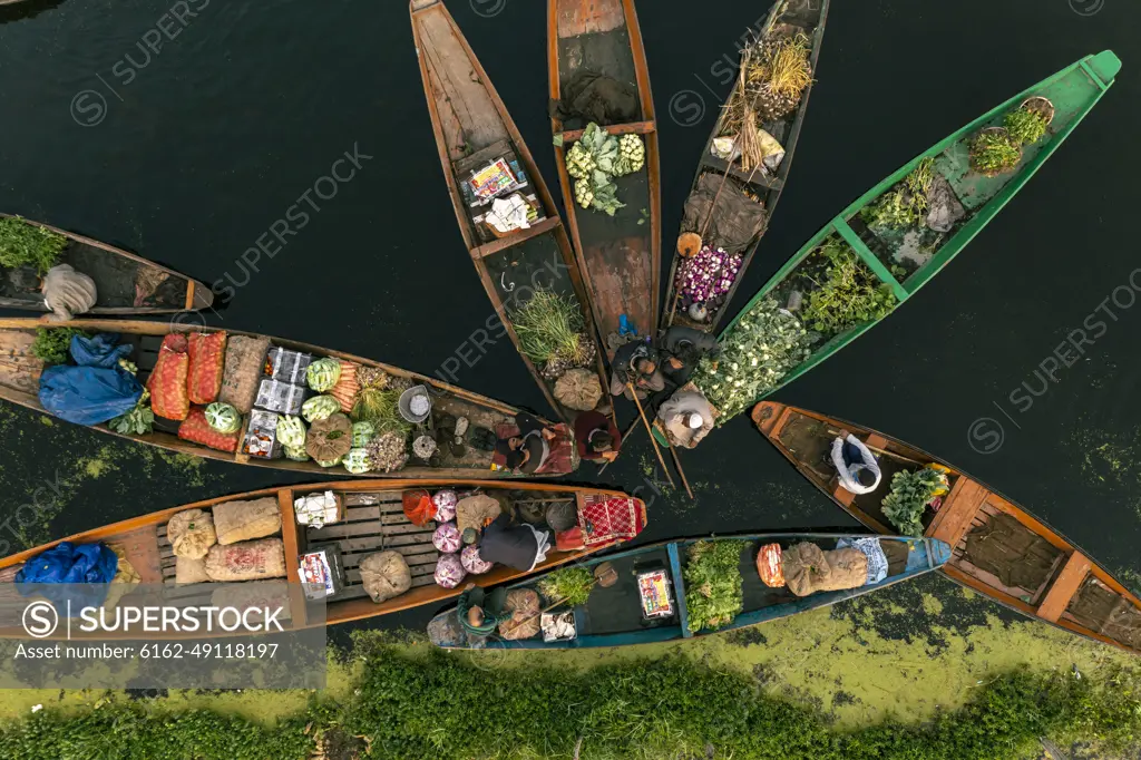 Aerial view of People on typical boats along the river during the floating market, Rainawari, Srinagar, Jammu and Kashmir, India.