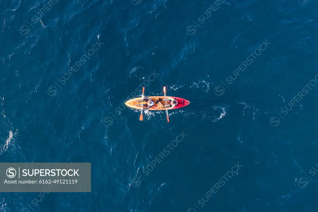 Azores, Portugal - 13 May 2021: Aerial view of two persons doing kayak in the ocean near San Miguel island, Azores islands, Portugal.