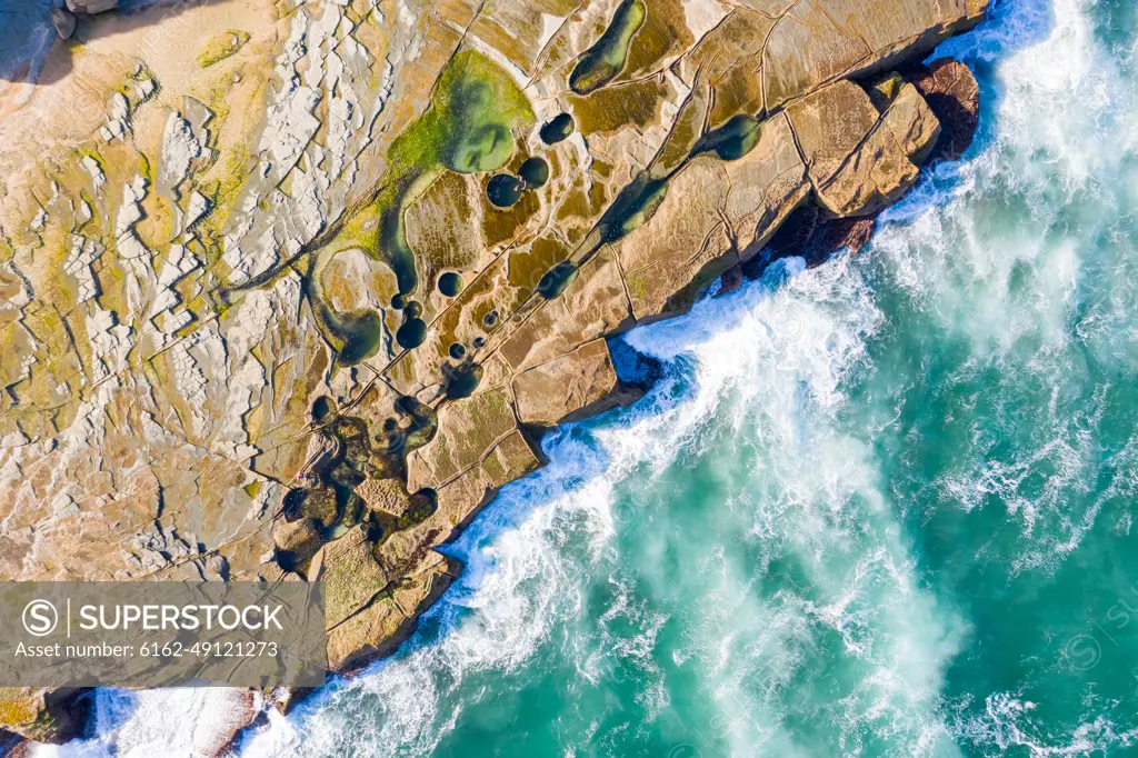 Aerial view above dangerous rock shelf in Sydney's Royal National Park, Australia.