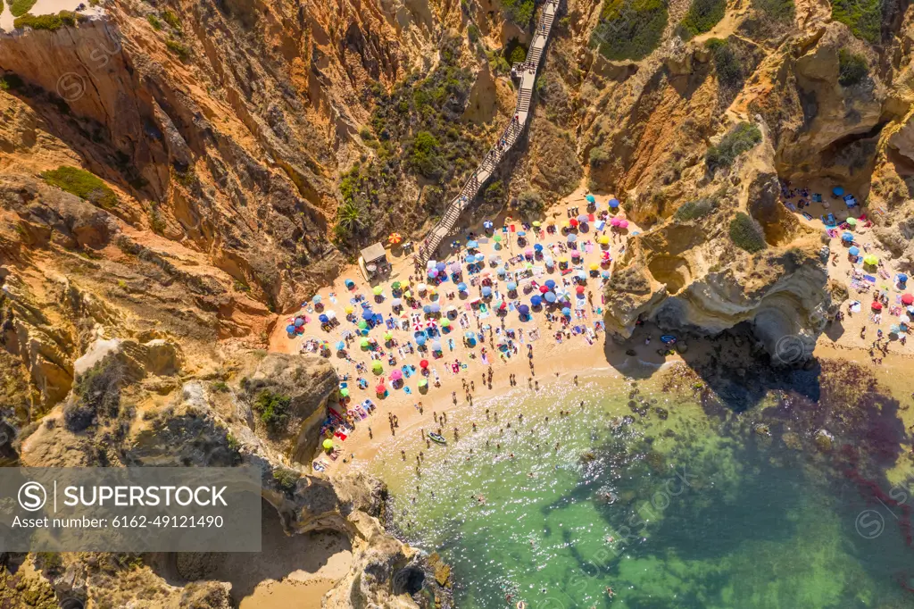 Aerial view of Praia do Camilo, hidden beach accessible by steep steps, Portugal.