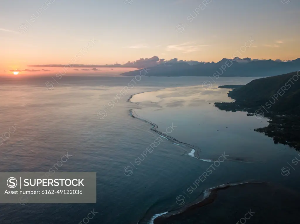 Aerial view of Tahiti coastline at sunset in French Polynesia.