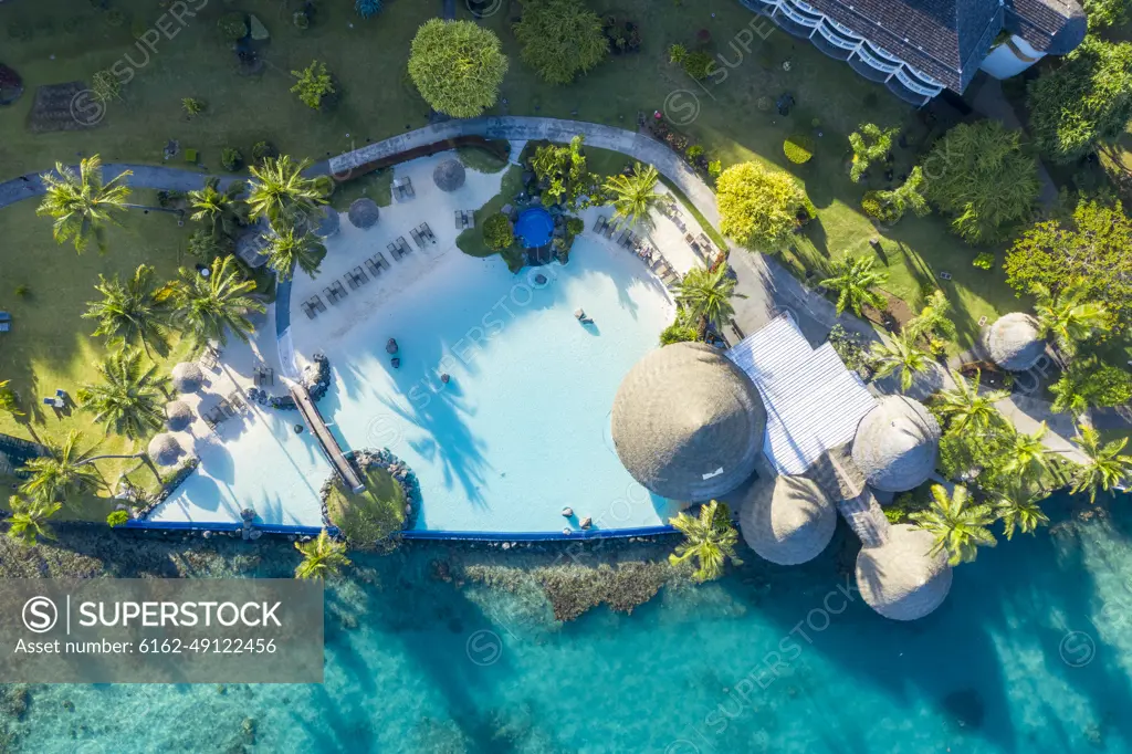 Aerial view of a swimming pool with garden of a luxury resort and hotel in Tahiti, French Polynesia.