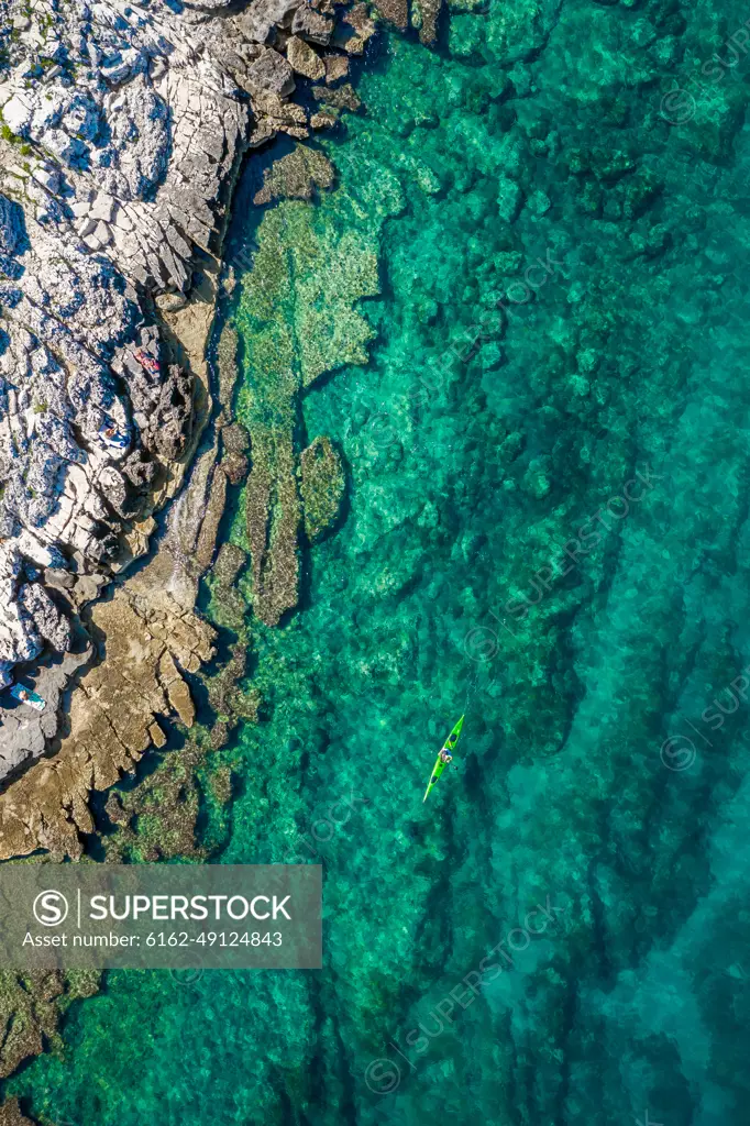 Aerial view of a kayak in the turquoise waters of Bale, Croatia