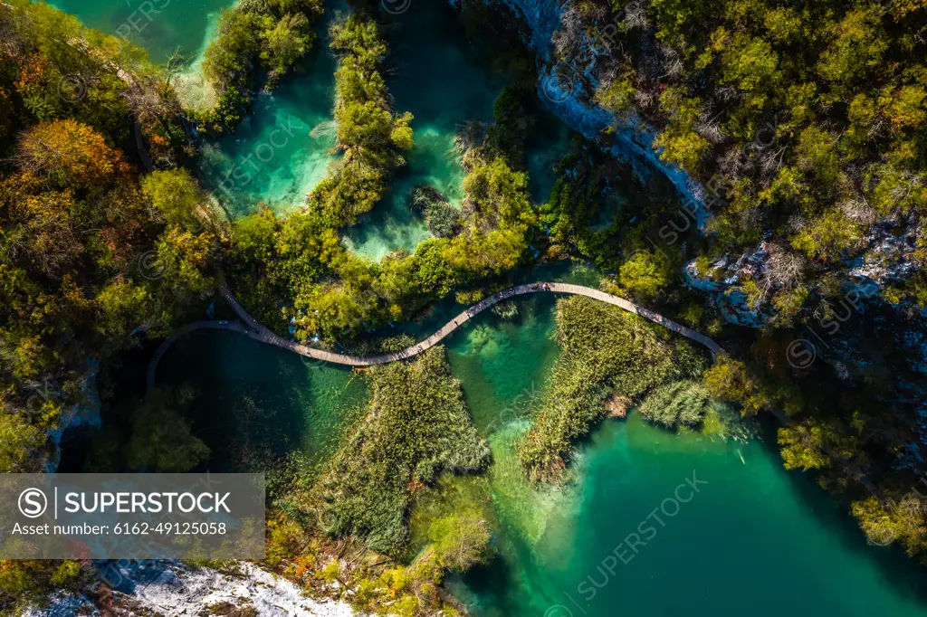 Aerial view of a wooden walkway surrounded by turquoise water in Lower Lakes, Korana, Croatia