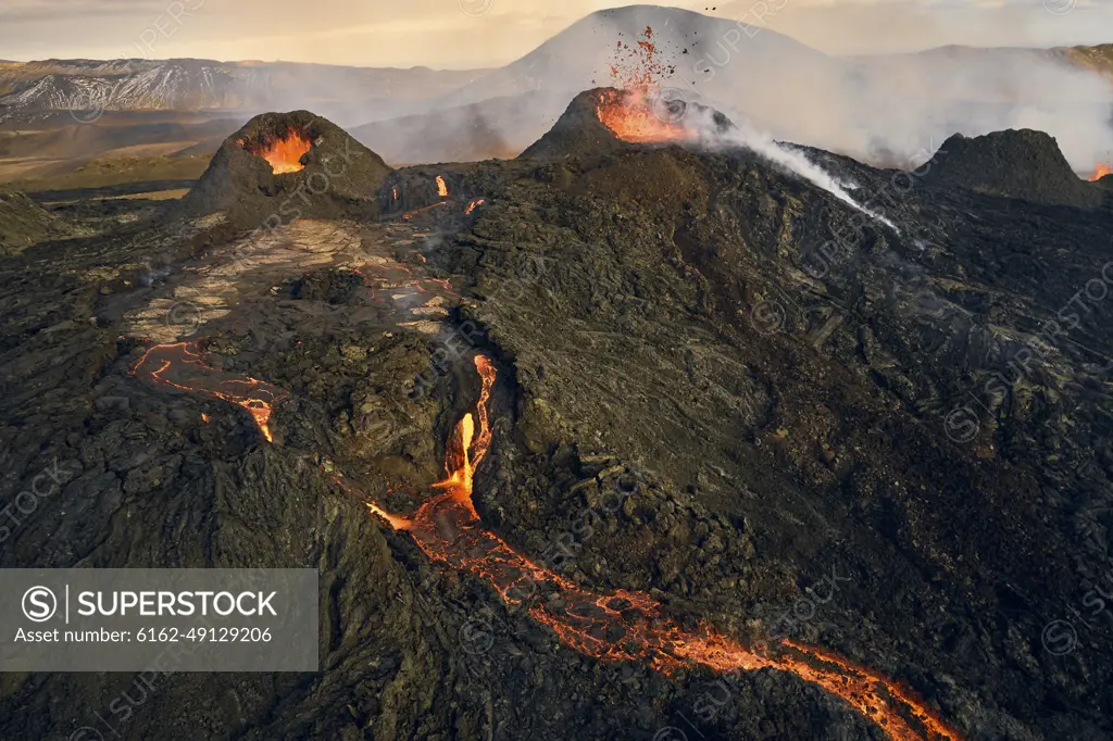 Aerial view of lava streaming down the mountain ridge, view of a river of lava flowing from the craters in Grindavík, Southern Peninsula, Iceland.