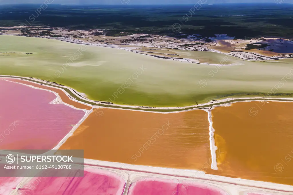 Aerial view of pink salt lakes along the coast at Ria Largatos Natural Park, Río Lagartos, Yucatan, Mexico.