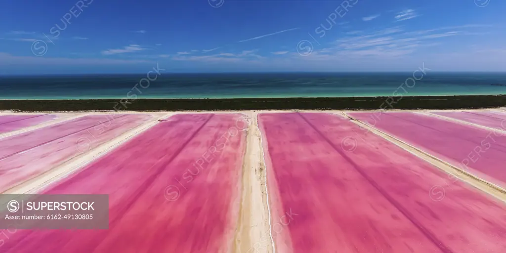 Aerial view of pink salt lakes along the coast at Ria Largatos Natural Park, Río Lagartos, Yucatan, Mexico.