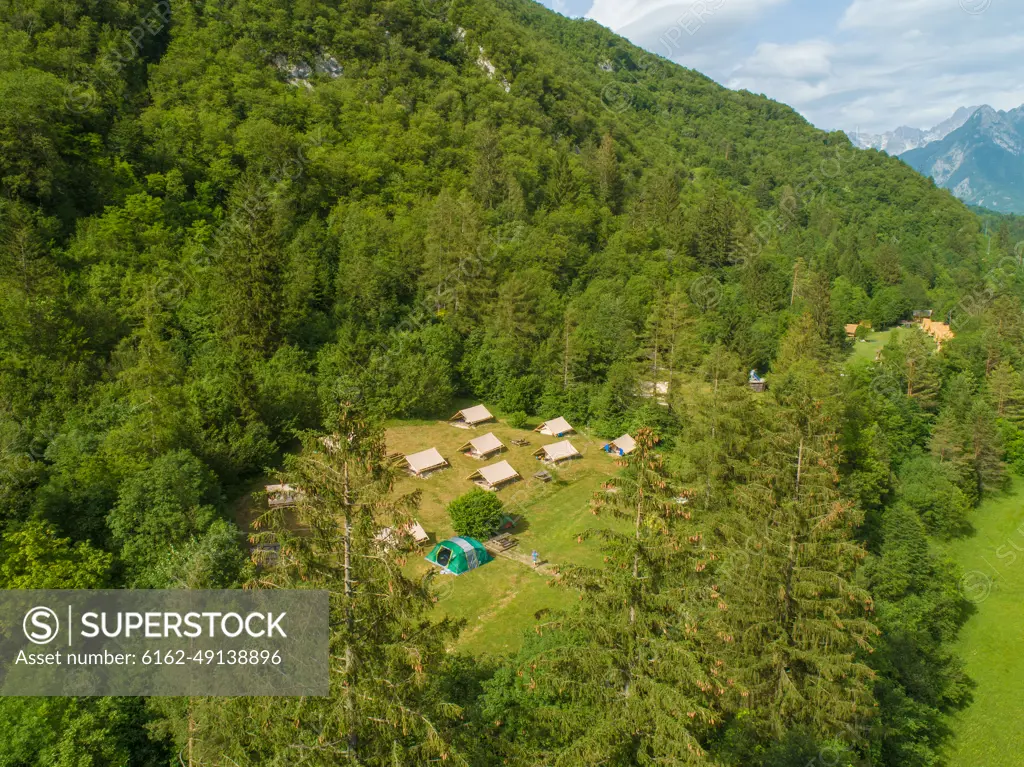 Aerial view of camping houses in the middle of the forest in the Soca valley, near Bovec, Slovenia.