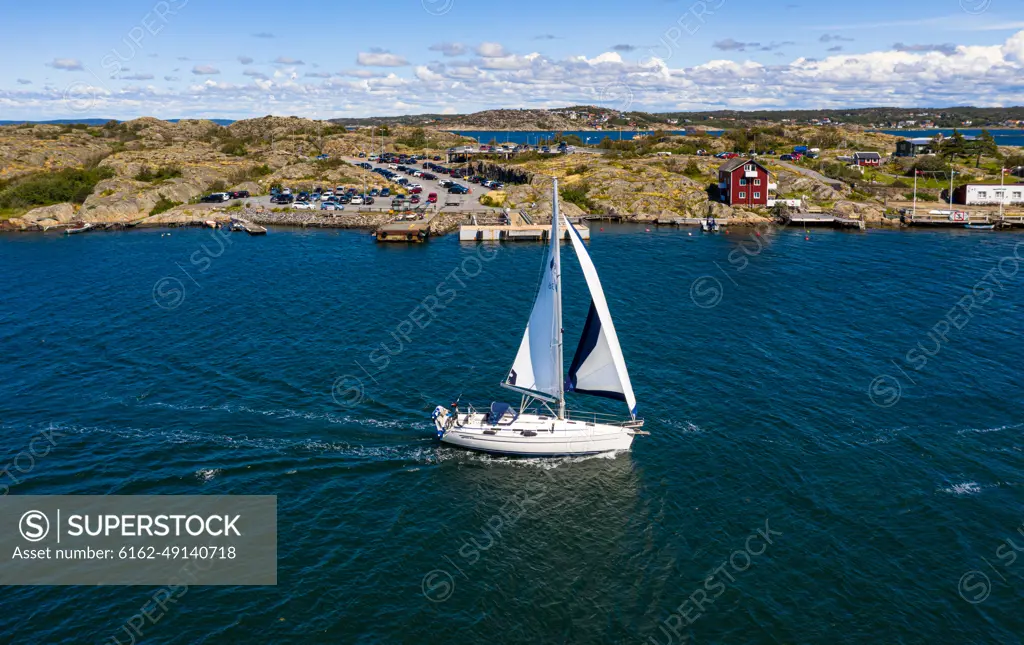 Aerial view of sailing boats cruising at the coast of Björkö island, Kattegat, Gothenburg archipelago, Sweden.