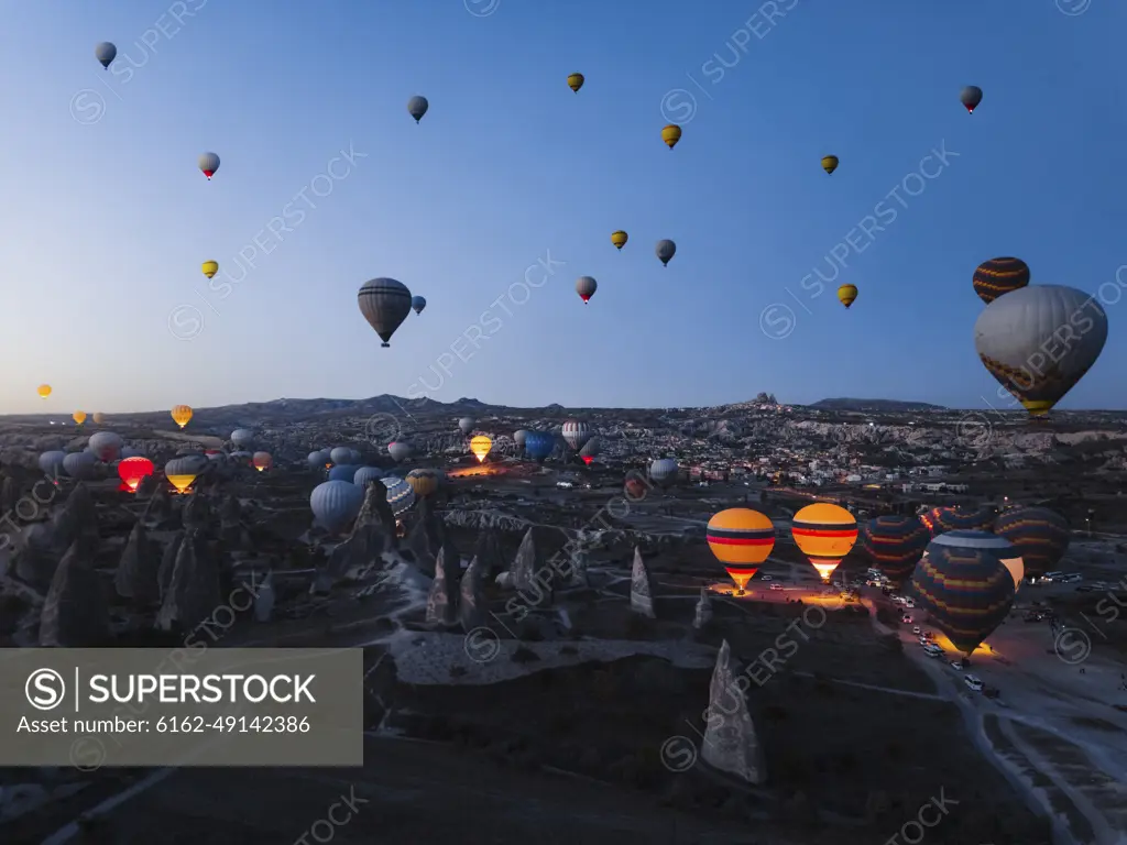 Aerial view of hot air balloons at sunrise in Cappadocia, Turkey.