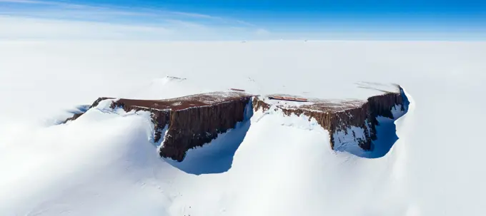 Panoramic aerial view of the SANAE IV base on a mountain surrounded by snow in Antarctica