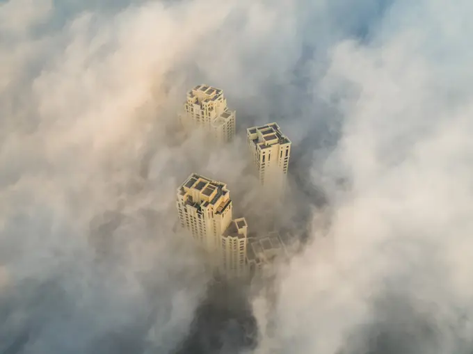 Aerial view of skyscrapers in the clouds of Dubai, U.A.E