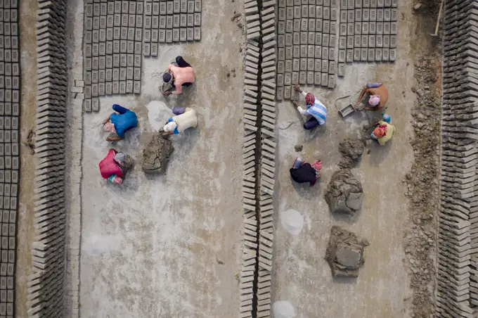 Aerial view of a brick factory from above, people working arranging the bricks near Keraniganj township, Dhaka province, Bangladesh.