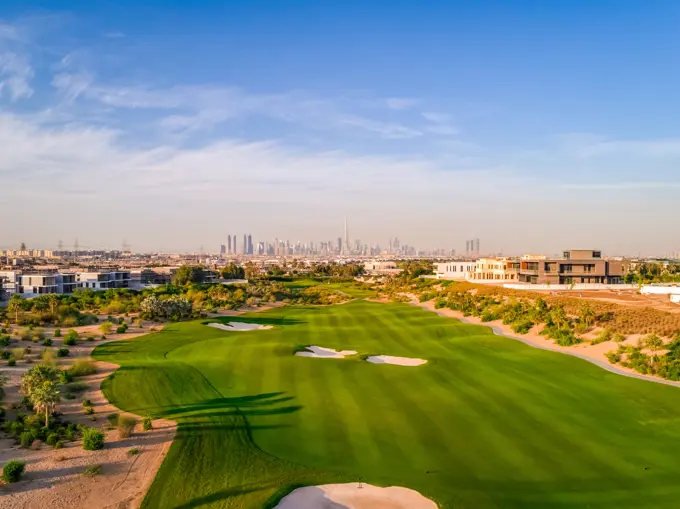 Aerial view of luxury golf club with Dubai at the background, U.A.E.