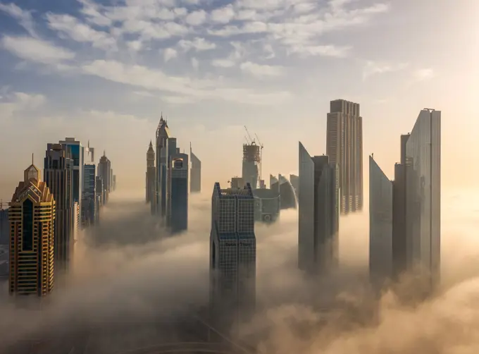 Aerial view of buildings surrounded by clouds Dubai, United Arab Emirates