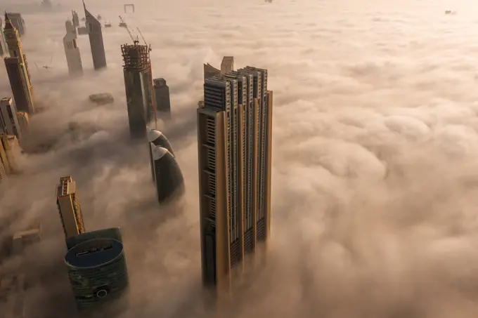 Aerial view of buildings surrounded by clouds Dubai, United Arab Emirates