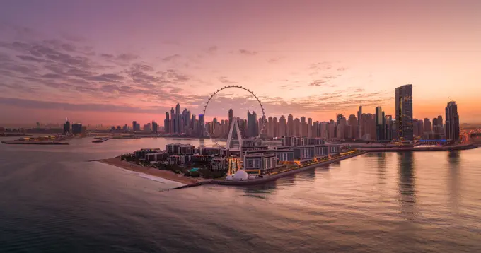 Panoramic Aerial view of Dubai skyline at sunset with Ain Dubai in foreground, the world's largest Ferris wheel, Dubai, United Arab Emirates.