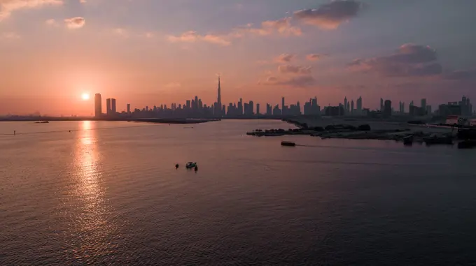 Aerial view of Dubai skyline facing the creek during a beautiful sunset, Dubai, United Arab Emirates.