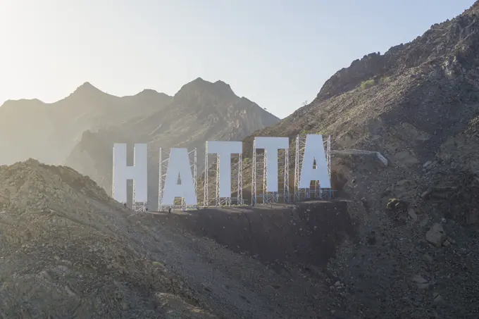 Dubai, United Arab Emirates - February 2022: Aerial view of the sign on the mountain top in Hatta, Dubai.