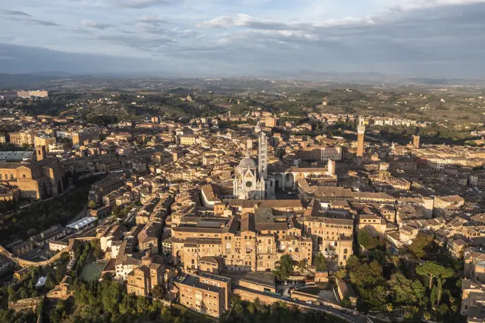 Panoramic aerial view of Siena cathedral in Siena downtown at sunset, Tuscany, Italy.