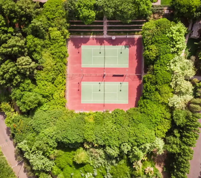 Aerial view of tennis courts in the middle of dense vegetation in Dubai, U.A.E.