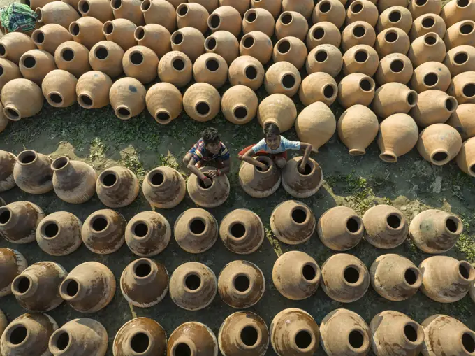 Manikgonj, Bangladesh - 20 February 2022: Aerial view of a kids working with clay pot in Manikgonj, Dhaka, Bangladesh.