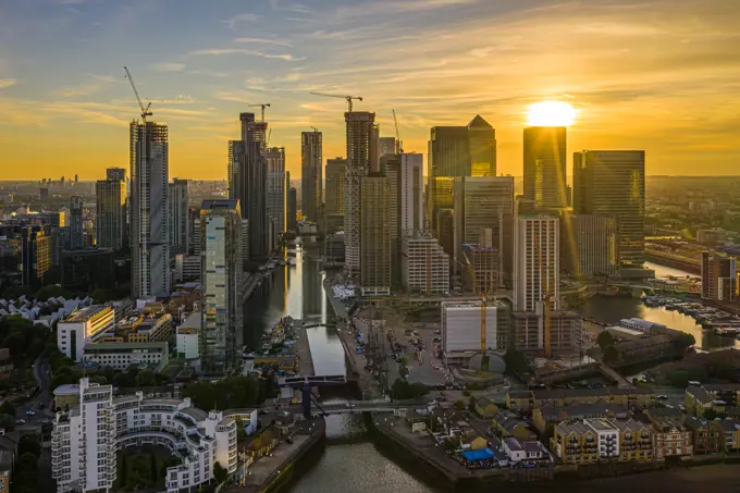 Aerial view of Canary Wharf financial district along the River Thams in London at sunset, United Kingdom.