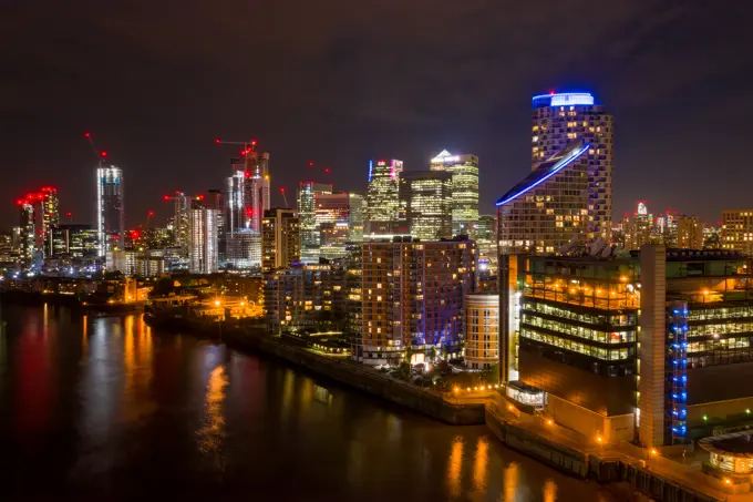 London, United Kingdom - 29 December 2020: Aerial view of London skyline along the river Thames at night.